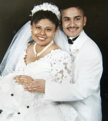 A man and woman in white wedding attire.