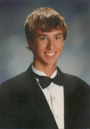 A young man in a tuxedo and bow tie.