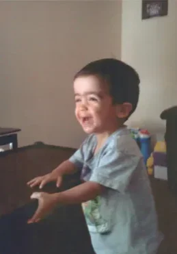 A young boy is playing with the wii.