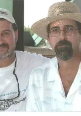 George Weldon Swearingen, Jr. Two men in white shirts and hats posing for a picture.