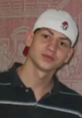 A man wearing a white hat and black shirt.