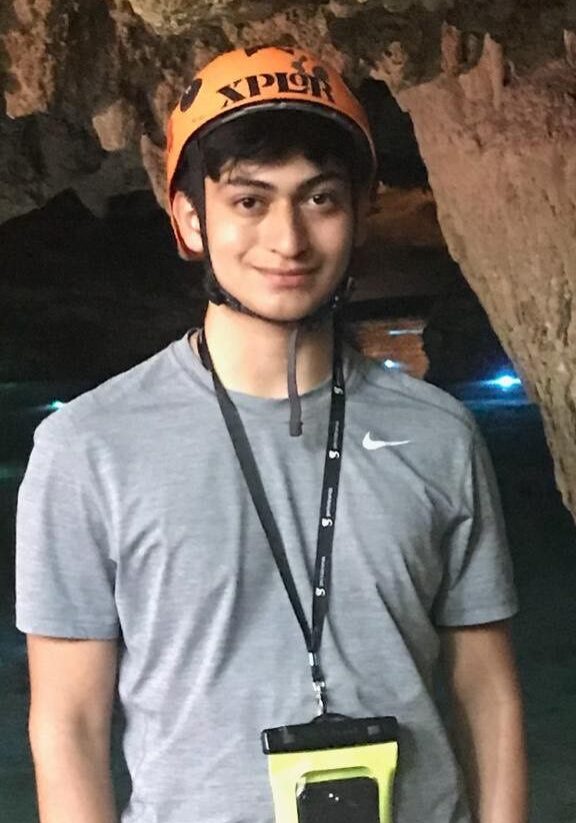 JesusRamos A man wearing an orange helmet and holding onto a black lanyard.