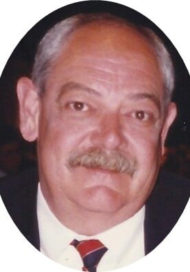 MIke A man with a mustache wearing a suit and tie.
