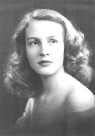 A young woman with long hair and bare shoulders.