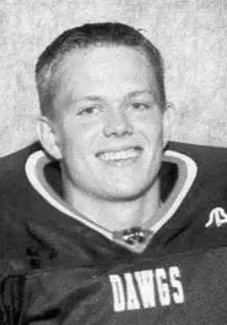 Matthew Self A man in a hockey uniform smiling for the camera.