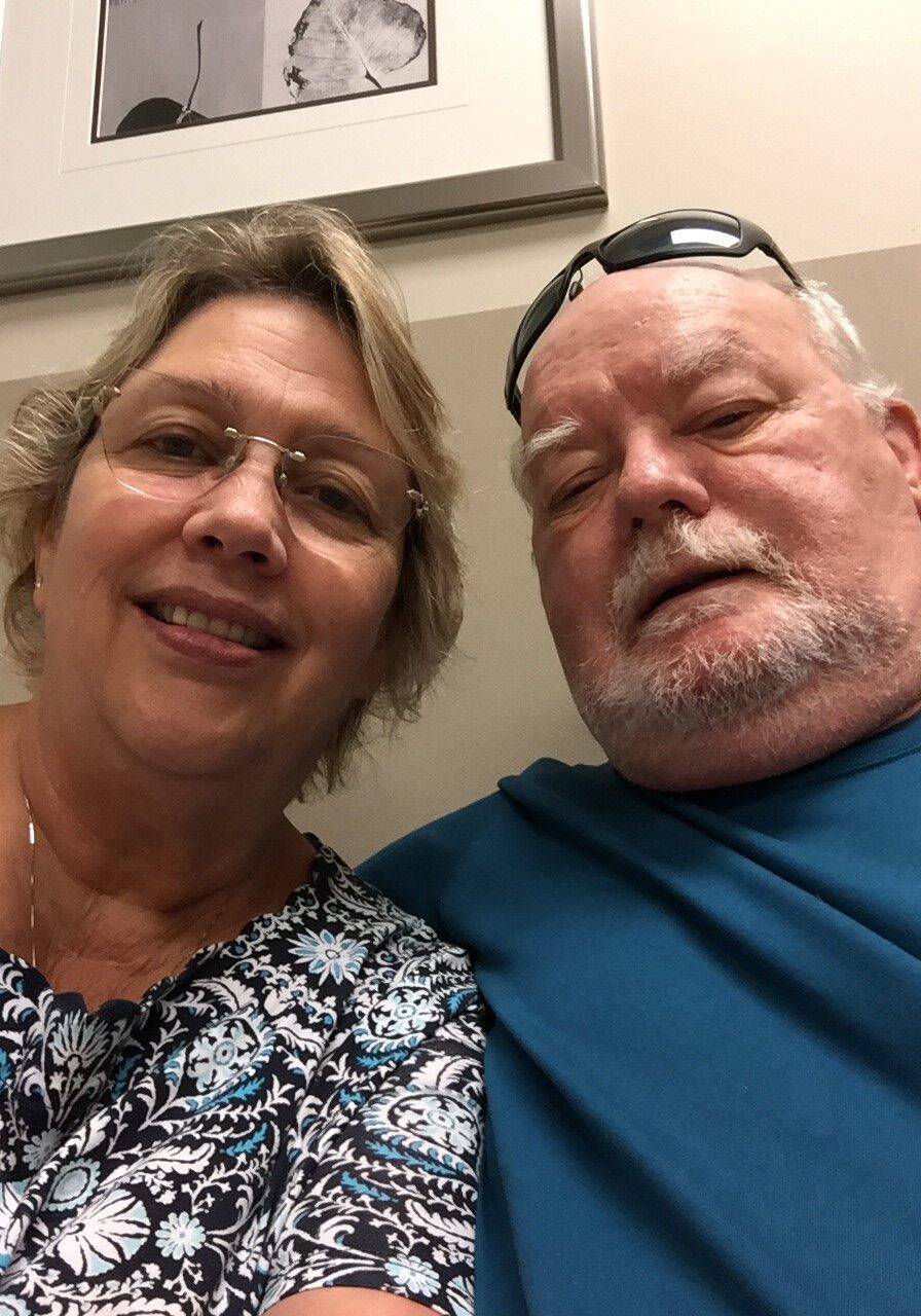 A man and woman pose for the camera.