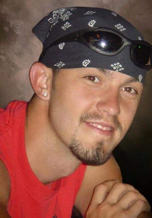 A man with sunglasses and bandana on.