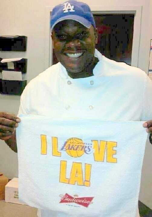 A man holding up a bag with the words " i love la !" on it.