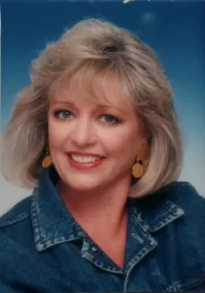 A woman with blonde hair and blue eyes.