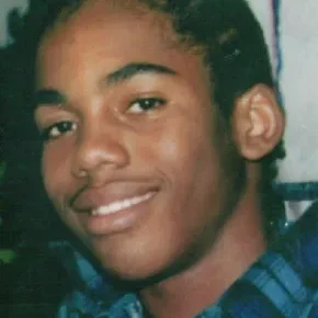 A young man smiling for the camera.